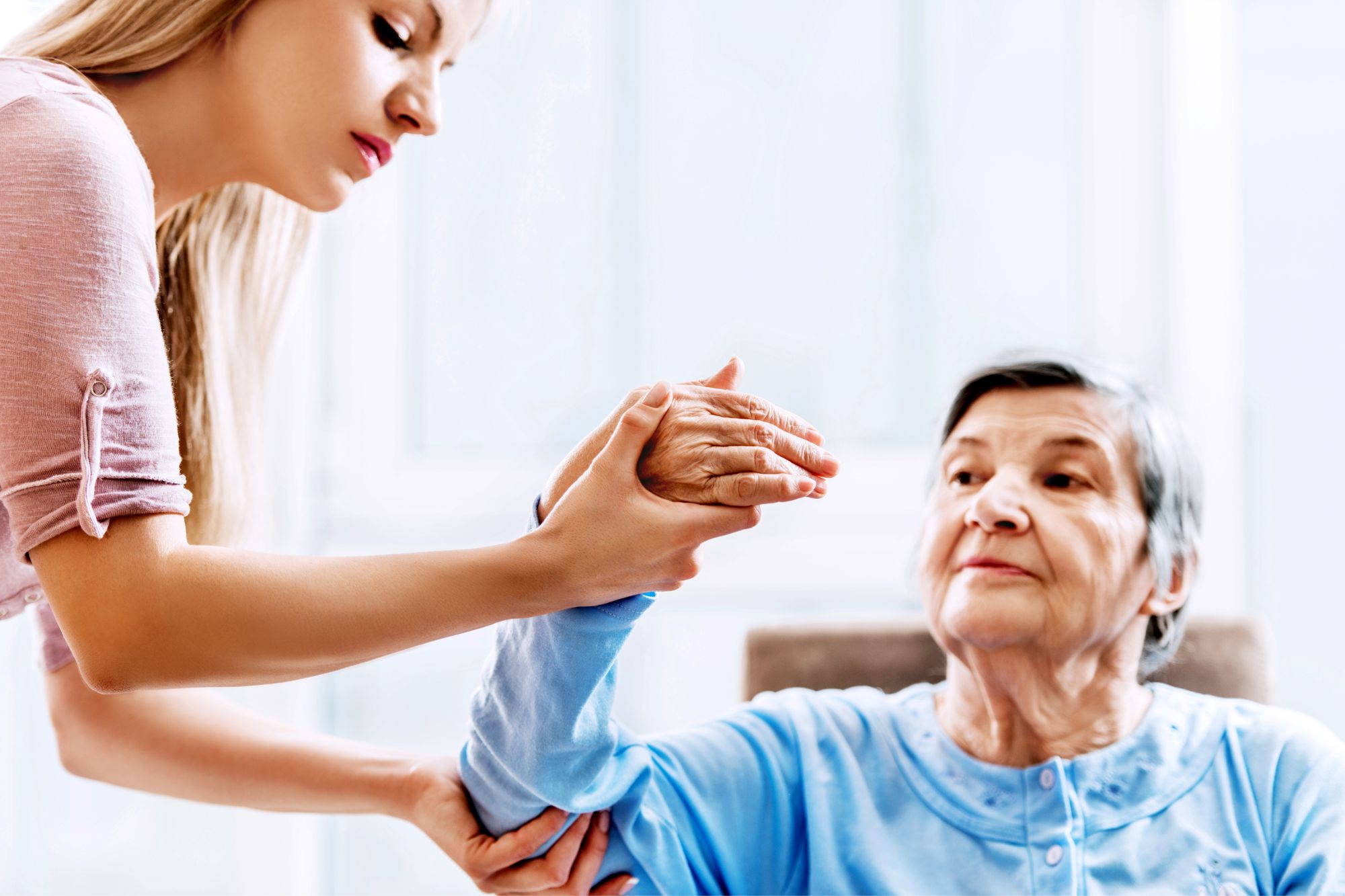 physical therapist helping elderly woman